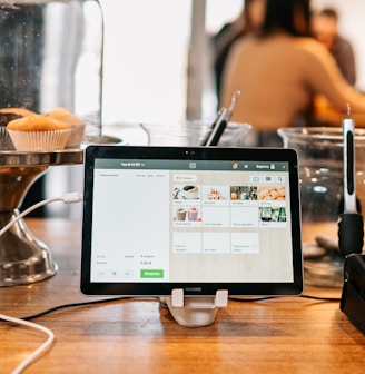 silver ipad on brown wooden table