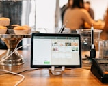silver ipad on brown wooden table