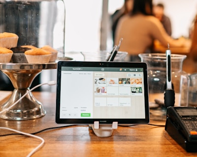 silver ipad on brown wooden table