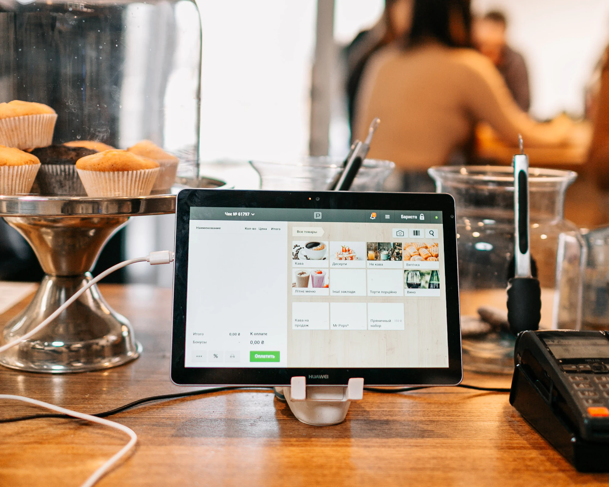 A bright, inviting café counter with a tablet point-of-sale in use