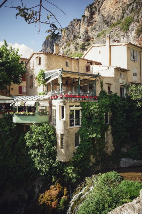 white and brown concrete building near green trees during daytime in Moustiers-Sainte-Marie France