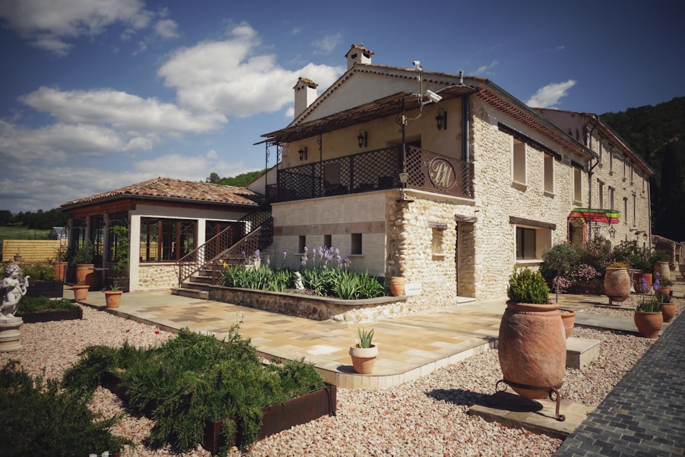 casa di cemento marrone e bianco sotto nuvole bianche durante il giorno