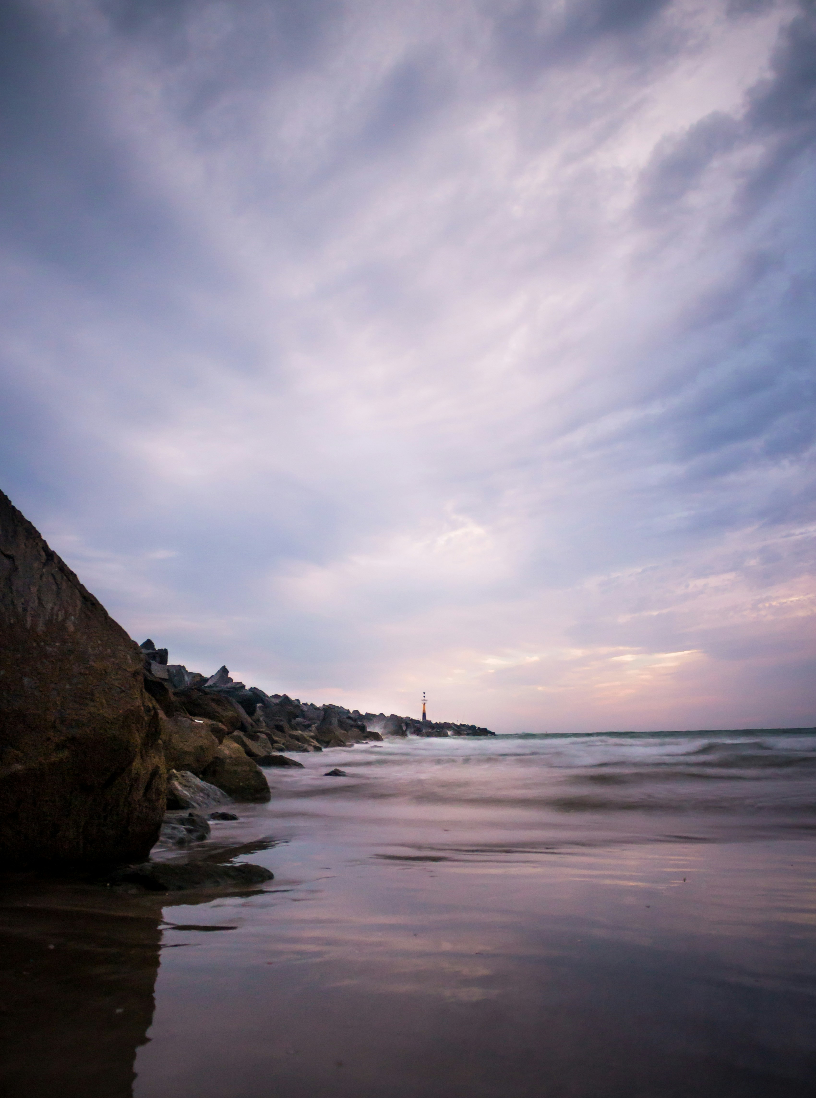 brown rock formation on sea shore during daytime