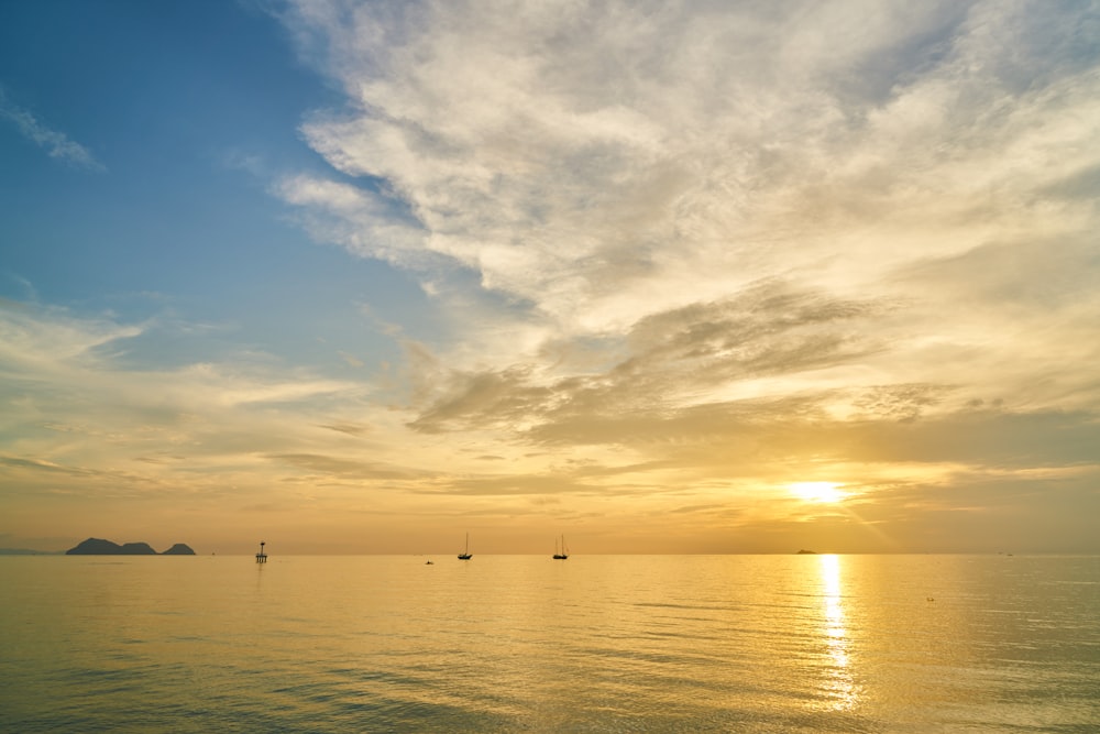 silhouette of person riding on boat on sea during sunset