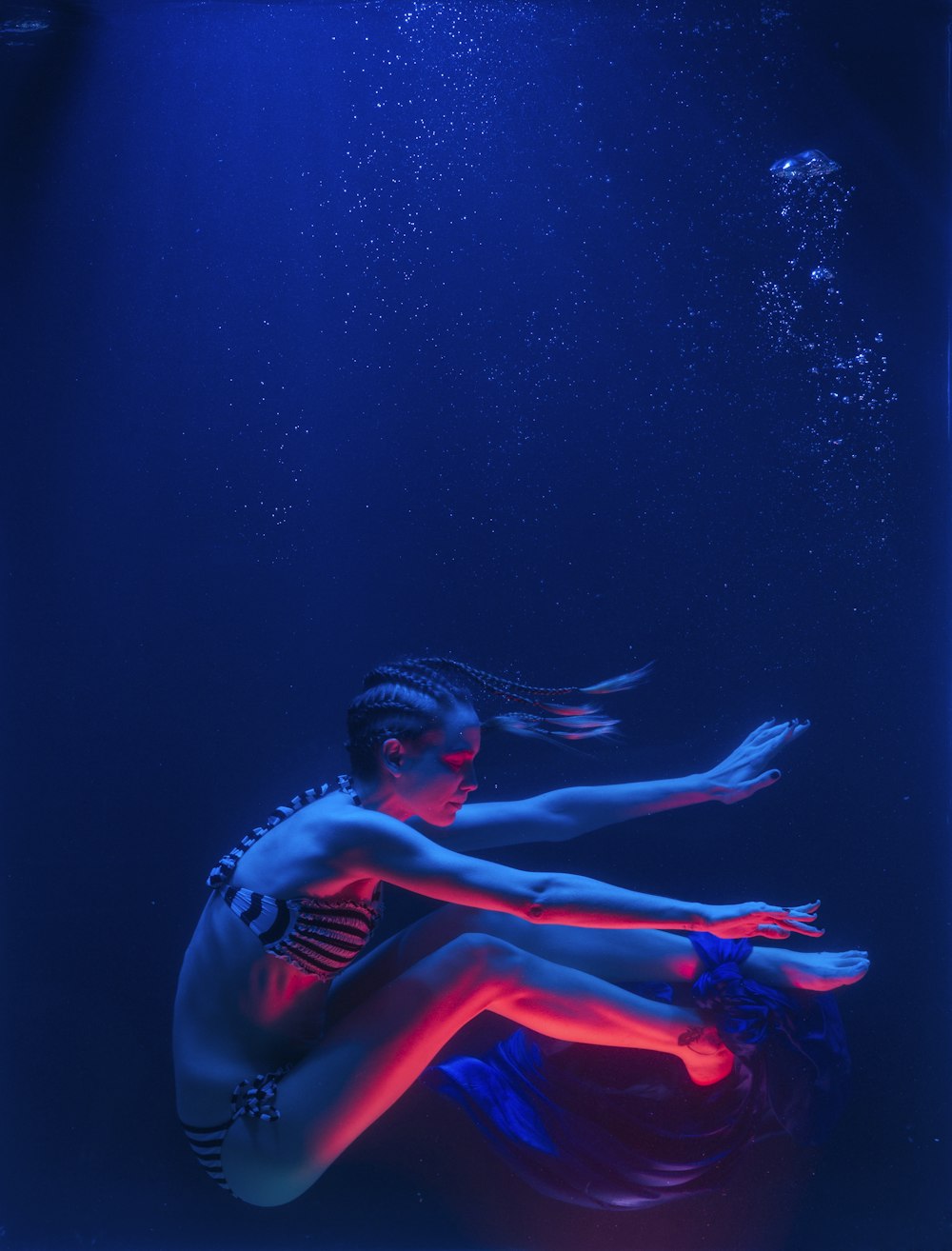 woman in red bikini under water