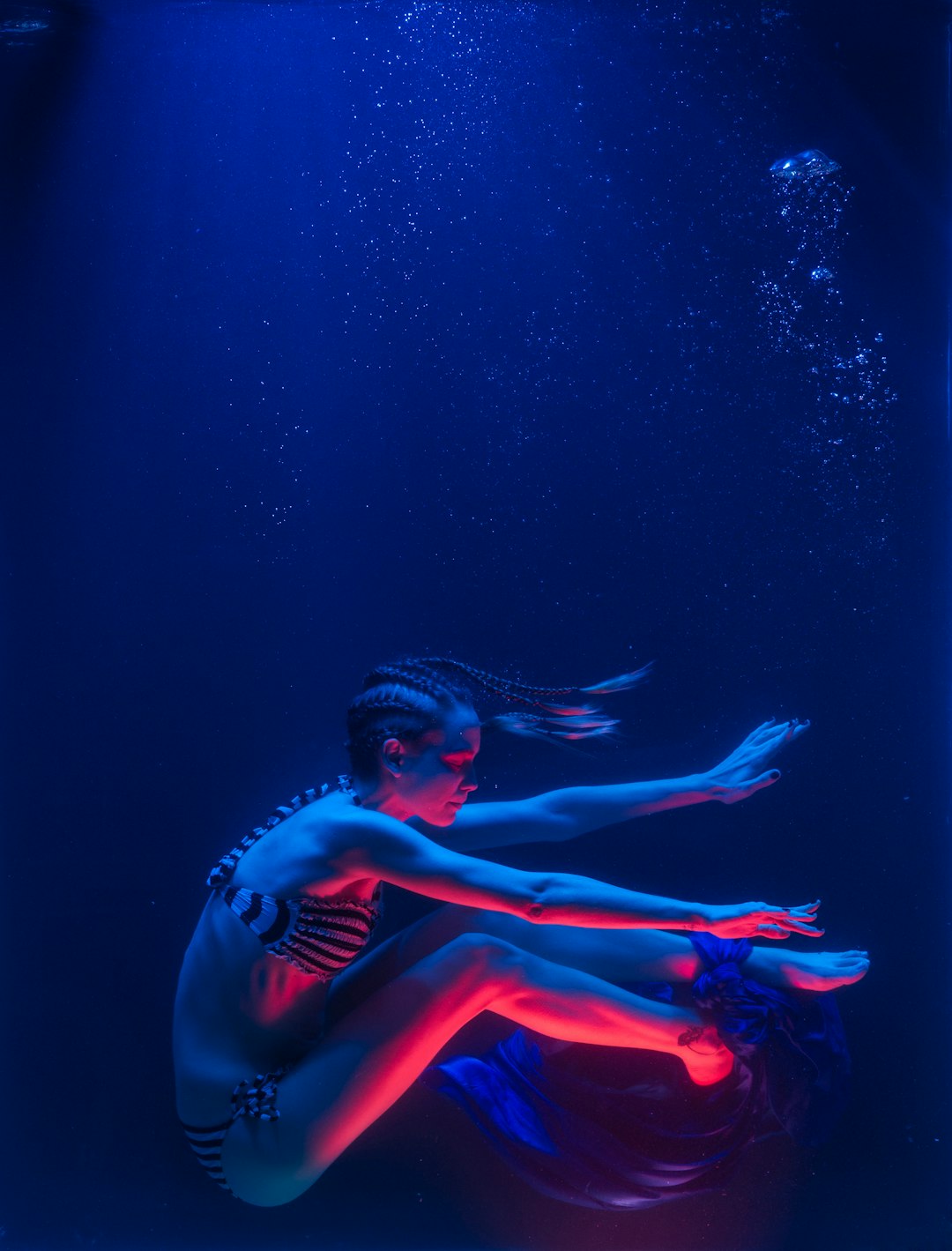 woman in red bikini under water