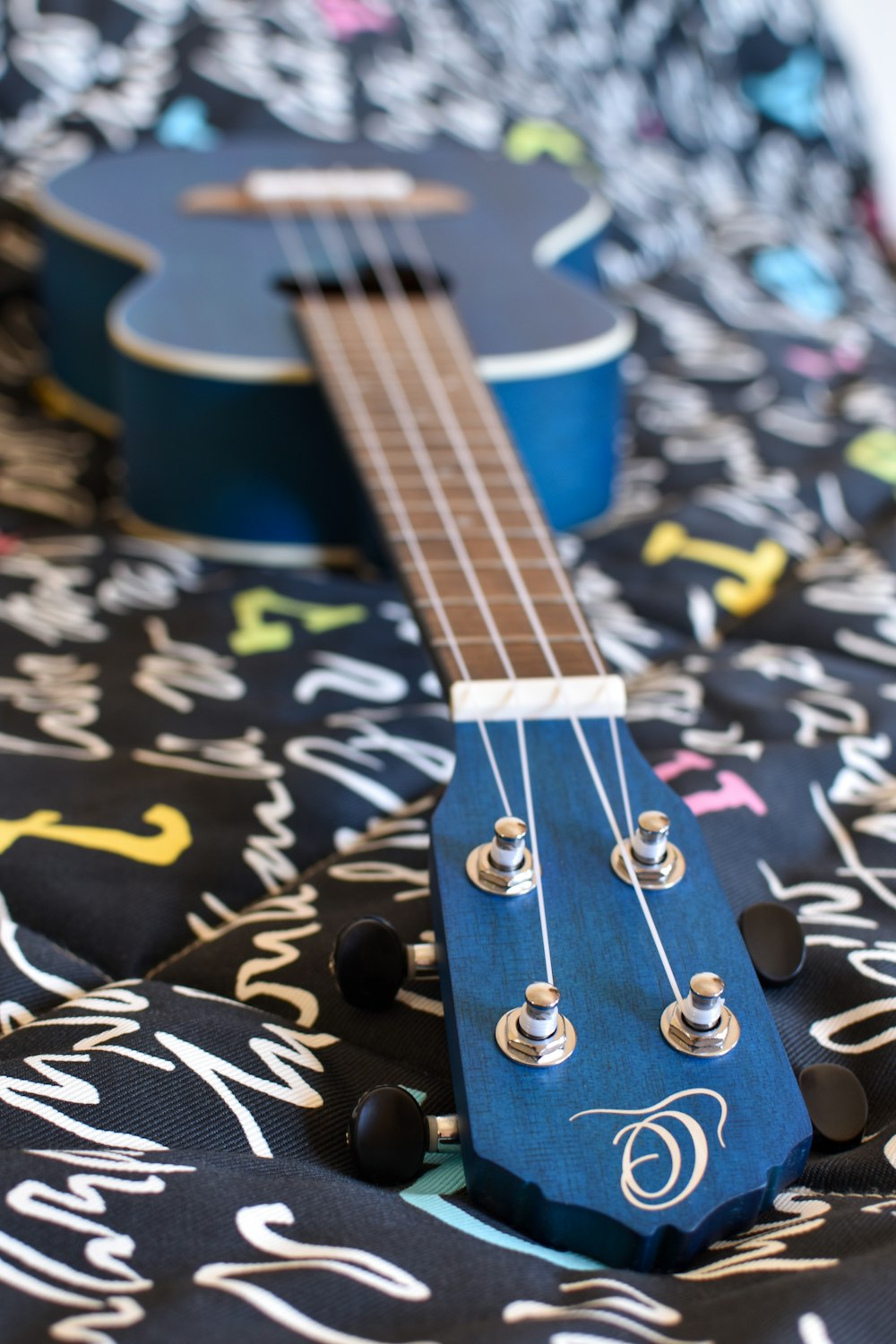 brown acoustic guitar on black and white textile