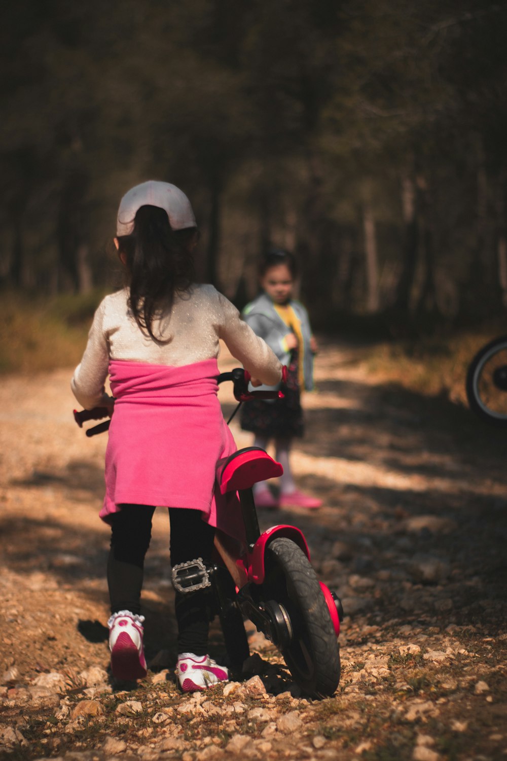 girl in pink dress riding on pink and black motorcycle during daytime