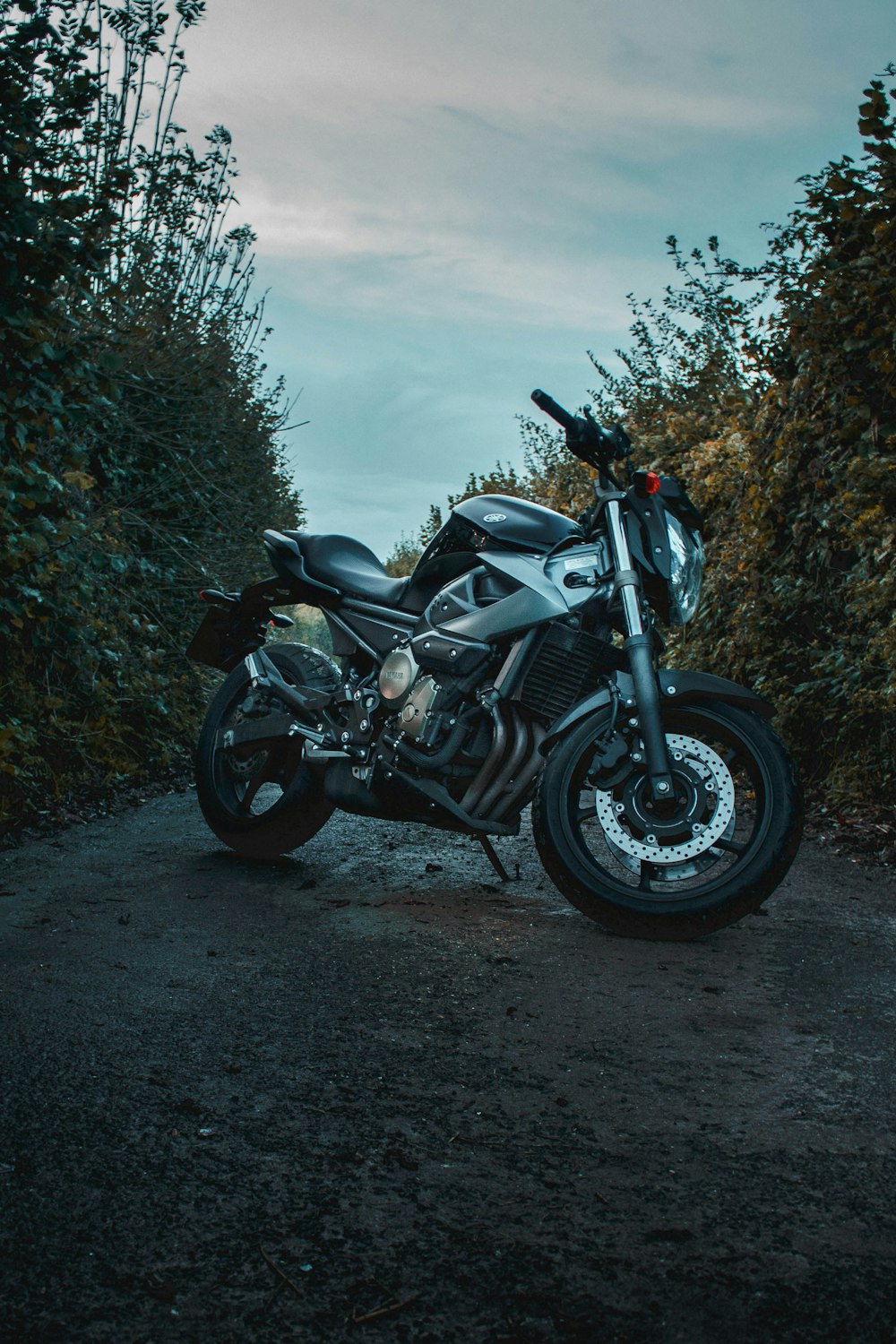 black and silver sports bike on dirt road