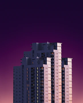 A corporate high-rise with purple-lit accents at dusk.