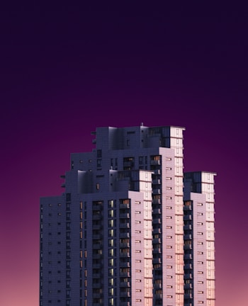 A modern high-rise building framed against a deep purple twilight sky.