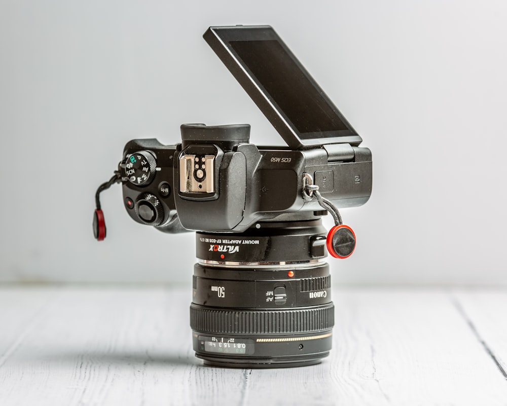 black dslr camera on white table