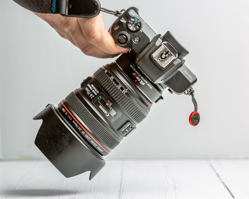 person holding black dslr camera