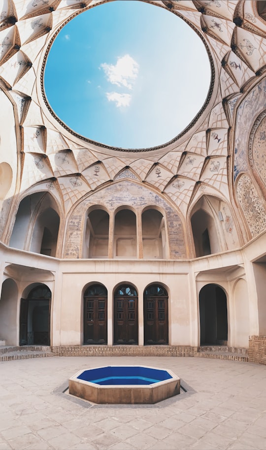 low angle photography of white concrete building under blue sky during daytime in Tabatabaei Historical House Iran