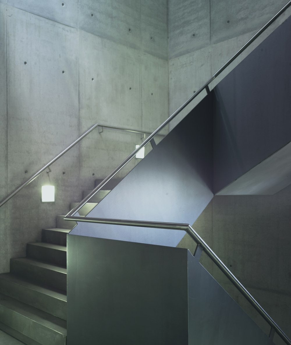 white and black staircase with stainless steel railings