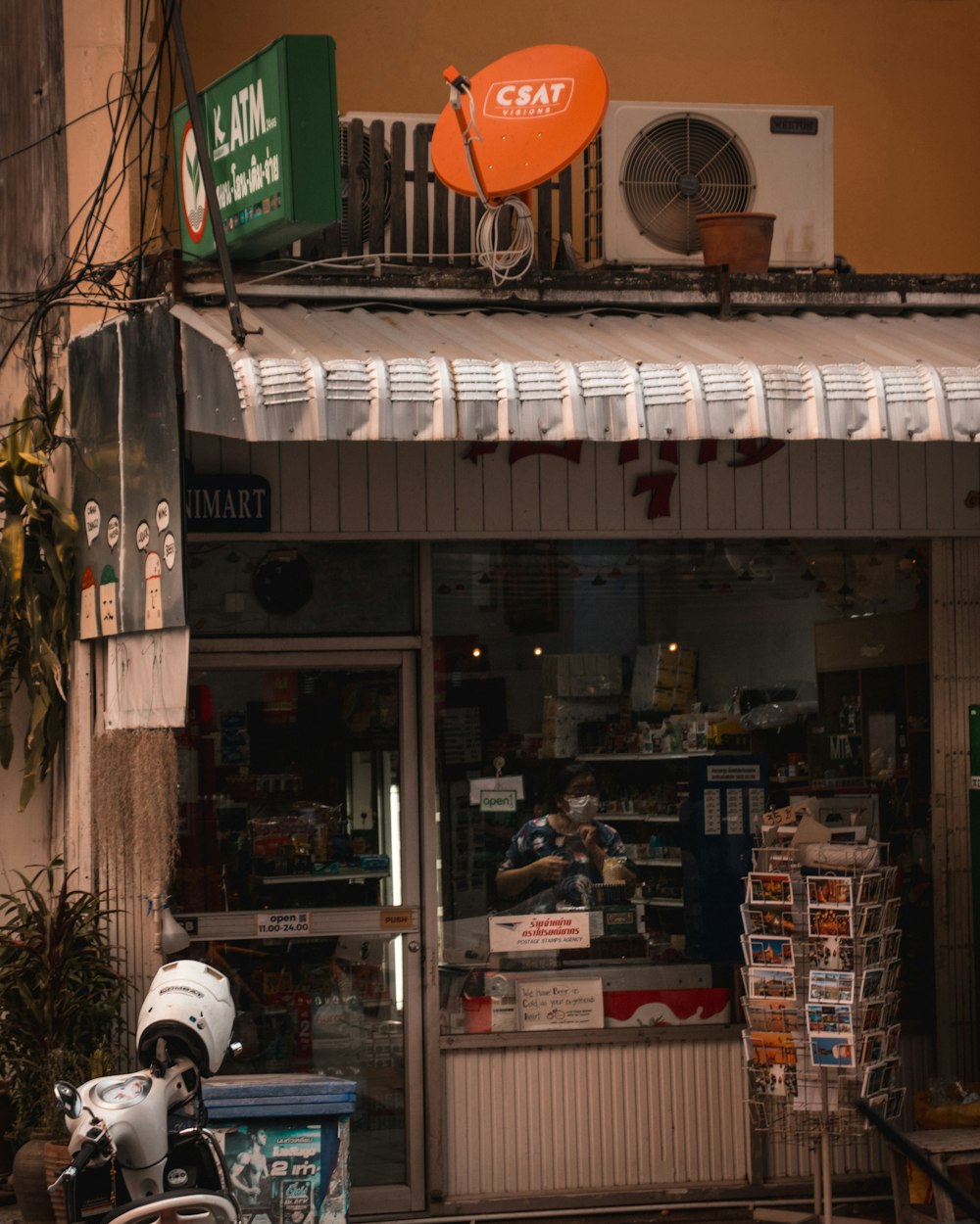 white and black motorcycle parked beside store during daytime