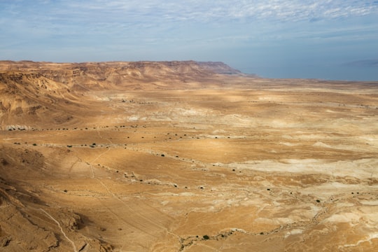 brown and gray mountains under blue sky during daytime in Masada National Park Israel