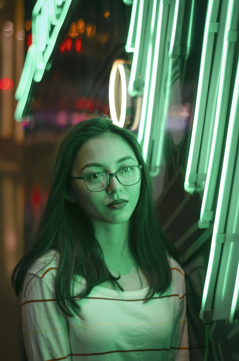 woman in green shirt wearing eyeglasses
