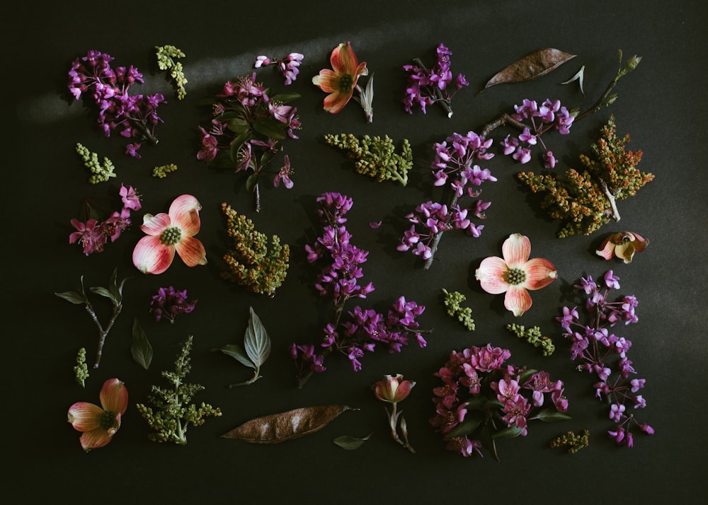 purple and white flowers on brown wooden table