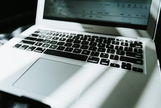 Close-up of a sleek laptop keyboard with natural light.