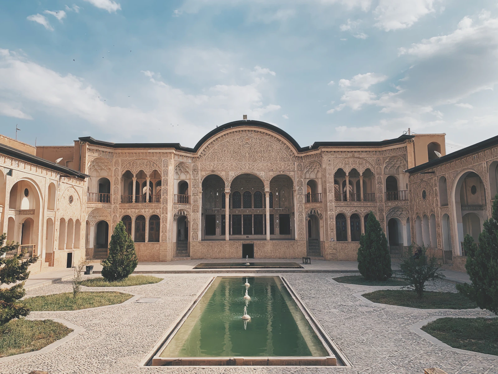 The courtyard and pool of a historic merchant house — Kashan, Iran
