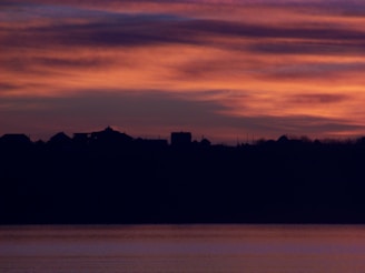 A vibrant sunset over a peaceful village, evoking a sense of storytelling.
