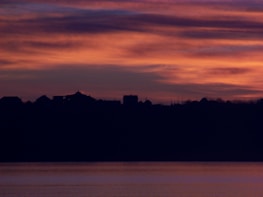 A serene sunset over a quiet village, inspiring poetic thoughts.