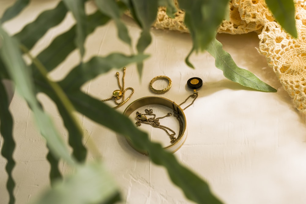 silver ring on white textile