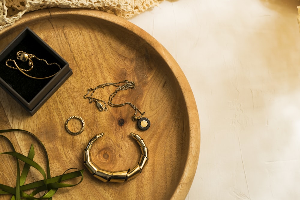 silver rings on brown wooden round tray