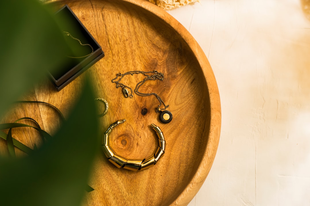 green and black smartphone on brown wooden round table