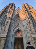 a man standing in front of a large cathedral