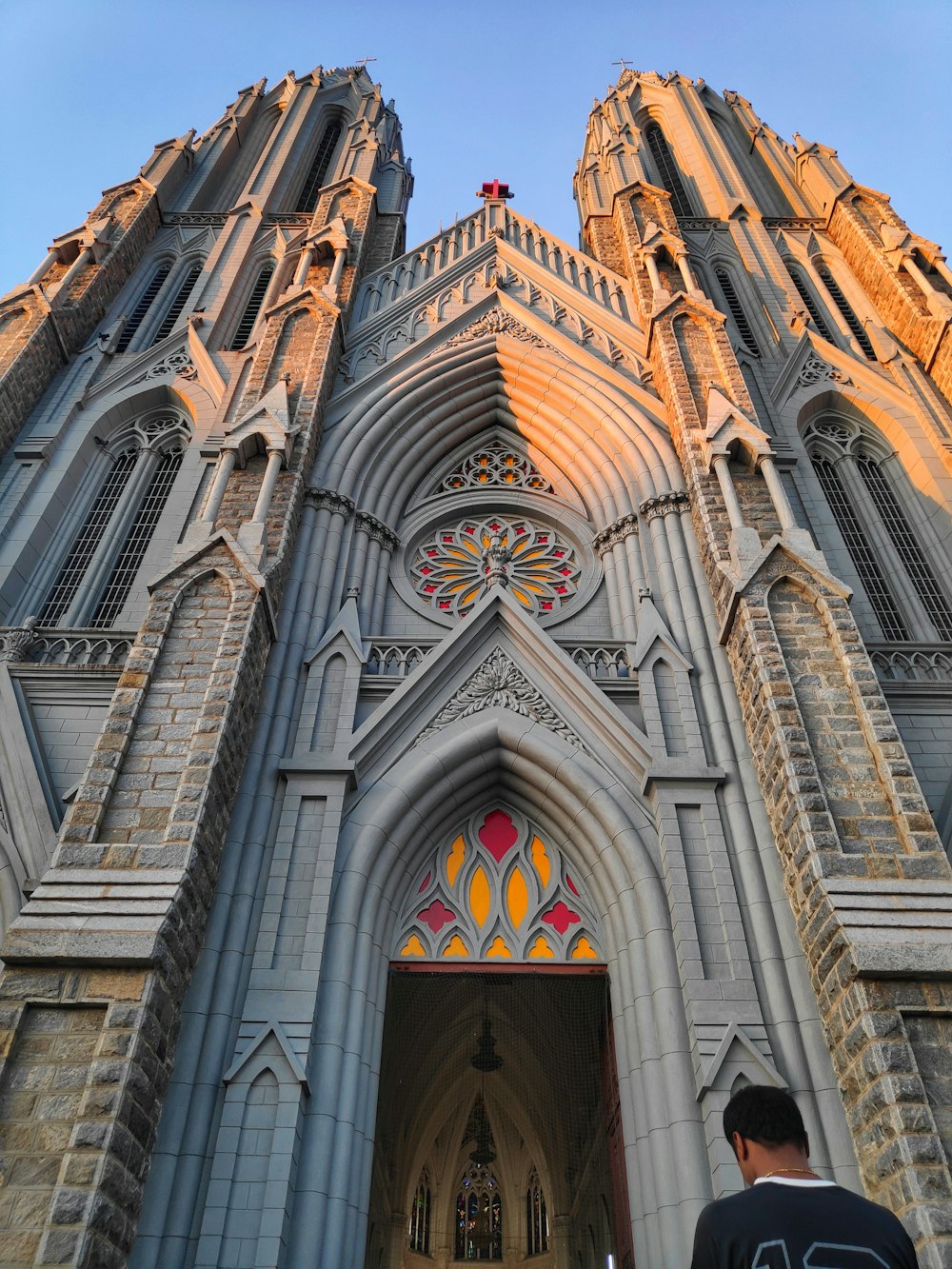 a man standing in front of a large cathedral