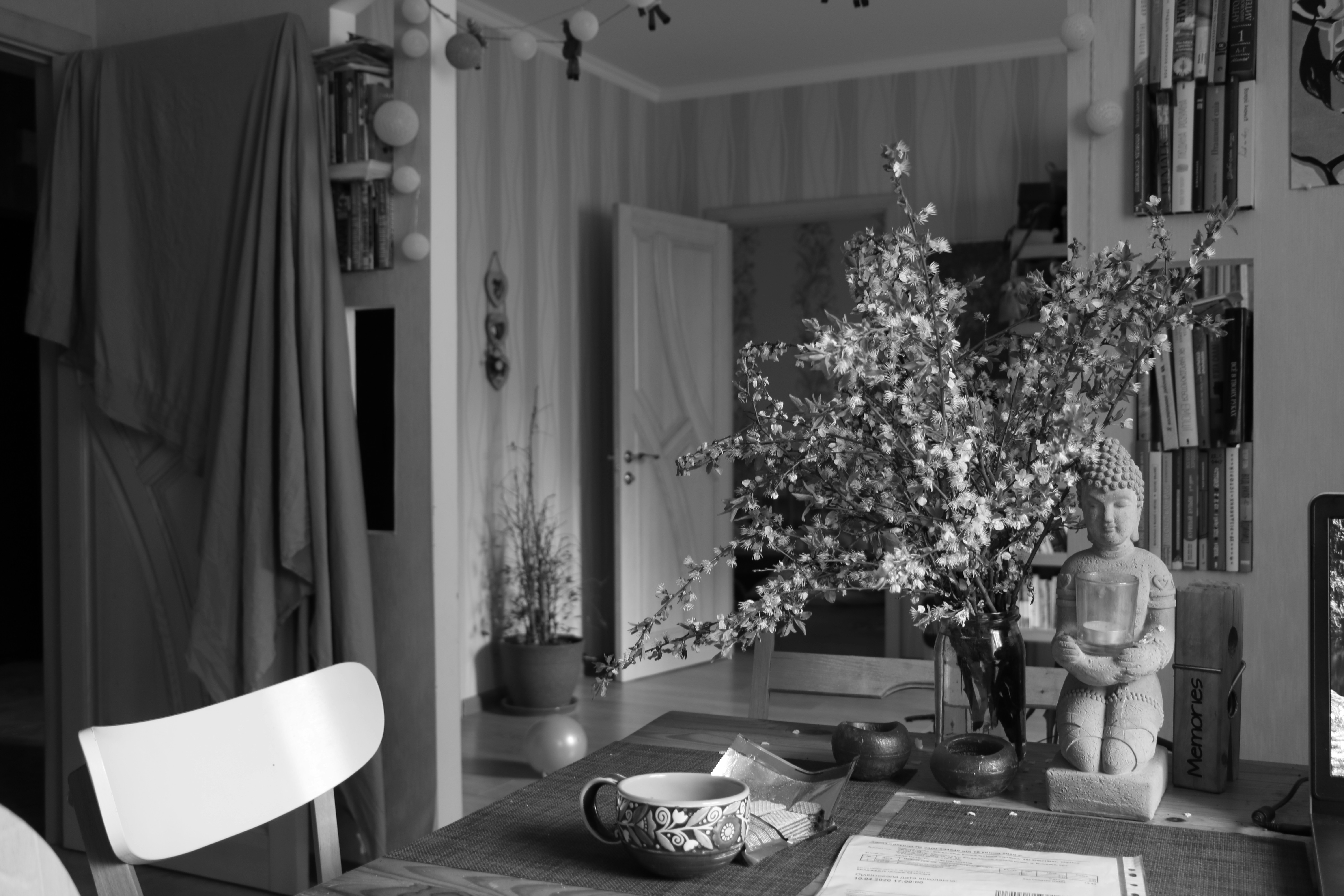 grayscale photo of dining table with chairs