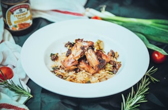A colorful plate featuring grilled vegetables alongside perfectly seasoned chicken and rice.