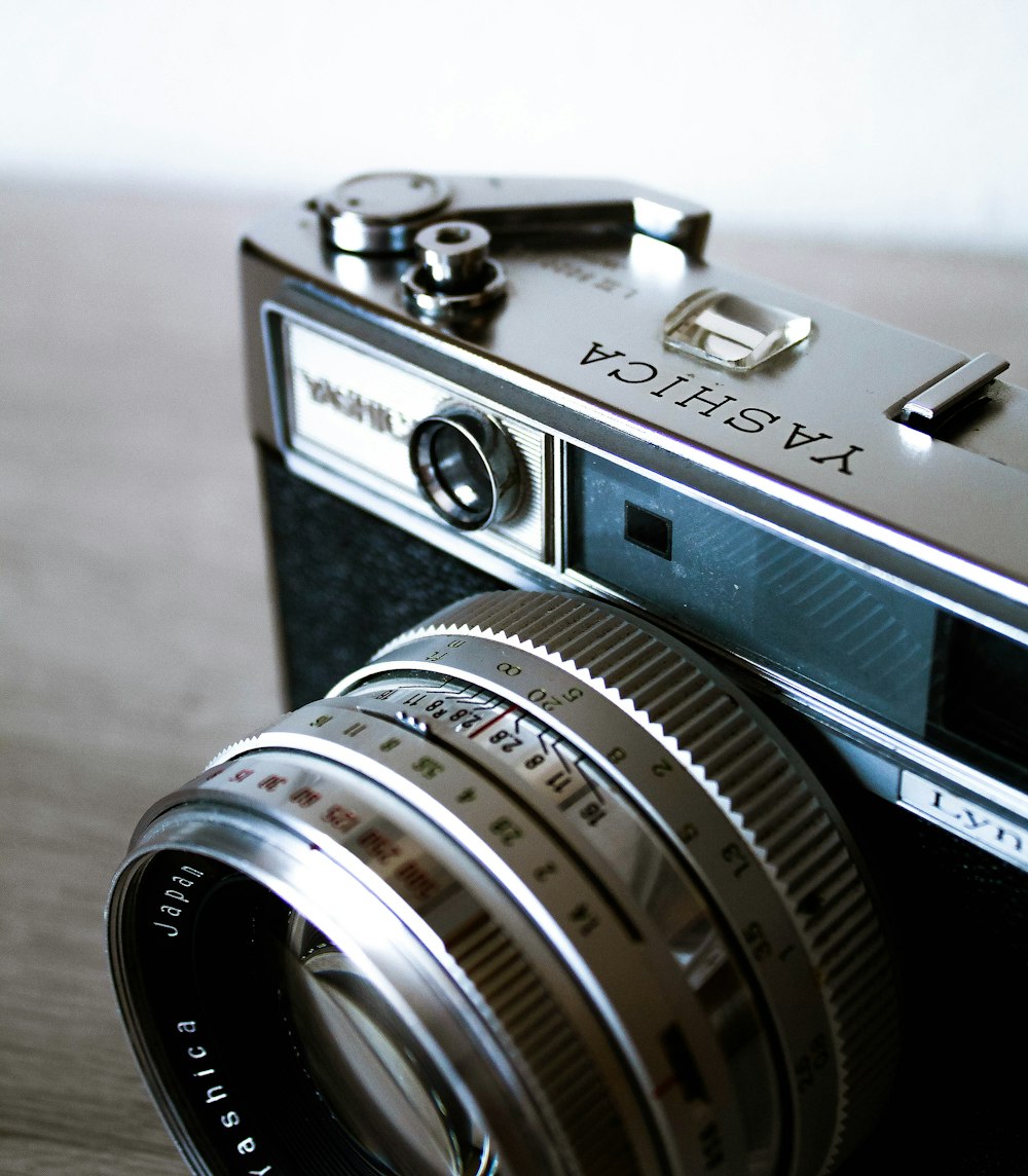 black and silver camera on brown wooden table