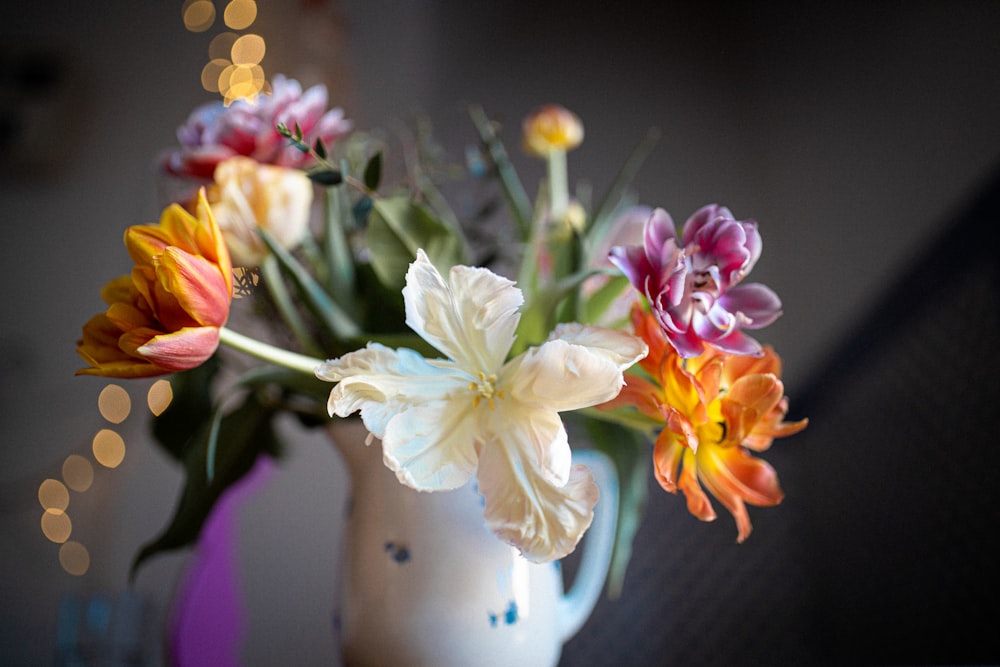 white and pink flowers in white ceramic vase