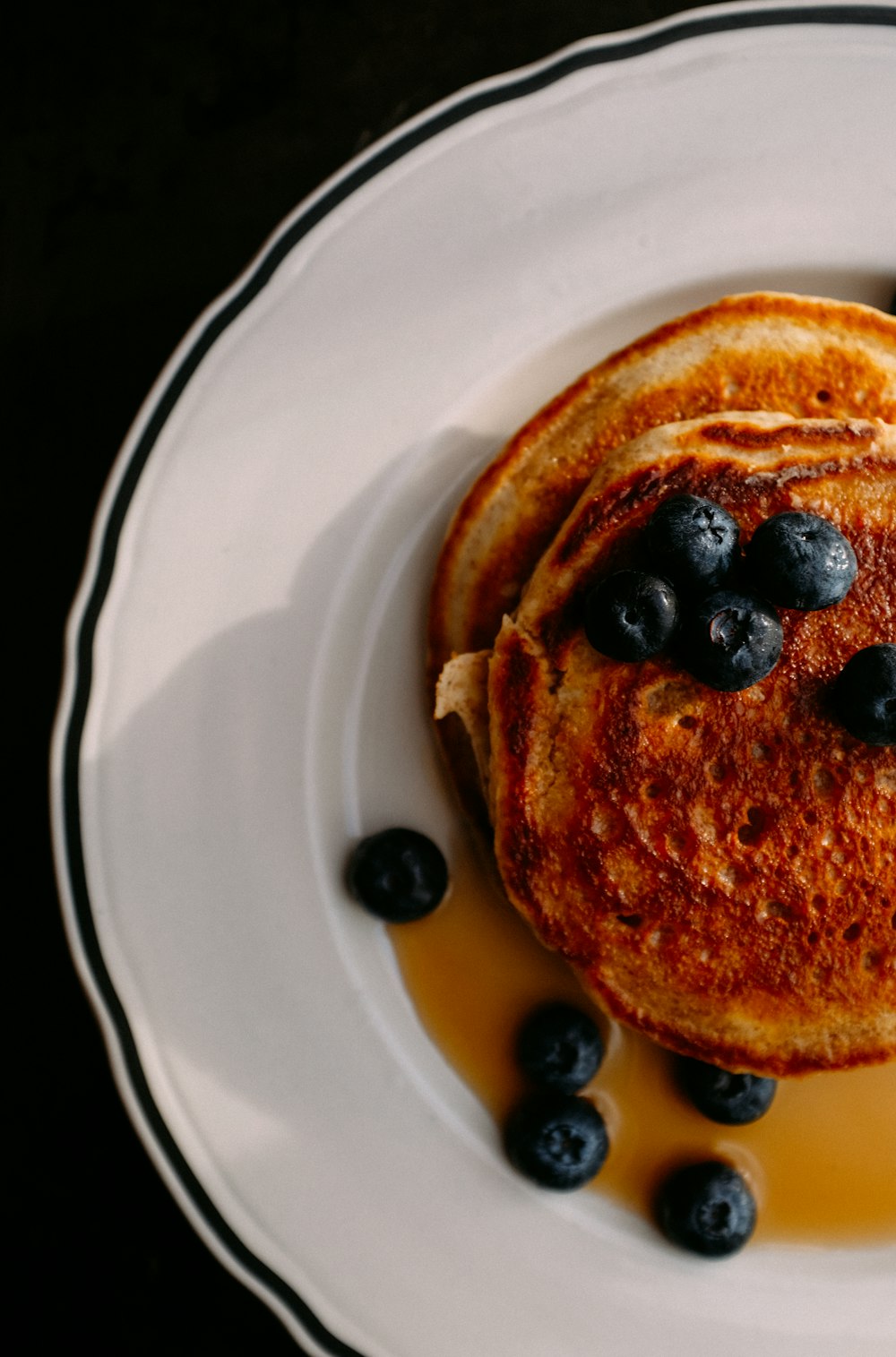 a white plate topped with pancakes and blueberries