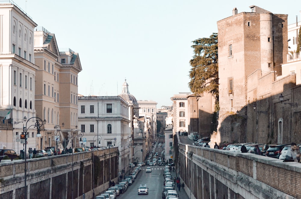 people walking on bridge near buildings during daytime