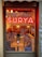 A warm and inviting view of a cozy restaurant interior with a prominent neon sign reading 'Surya' above the text 'Indian Street Food & Drinks'. The inside features a rustic decor with wooden tables and a mixture of chairs. Dim lighting and pendant lamps create a relaxed atmosphere, while reflections in the window hint at street art and an urban setting outside.