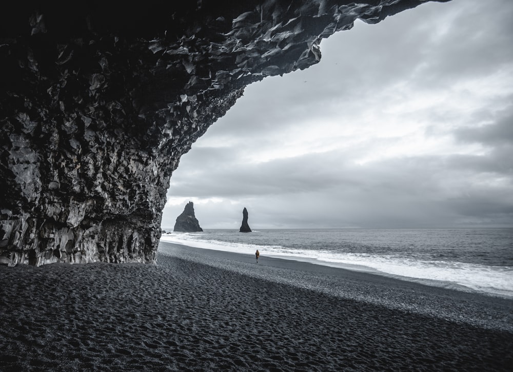 person in black shirt walking on beach during daytime