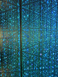 Close-up of vibrant LED curtain strands illuminating a shop window with dynamic colors.