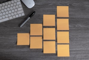 yellow sticky notes beside white apple magic mouse and white apple keyboard