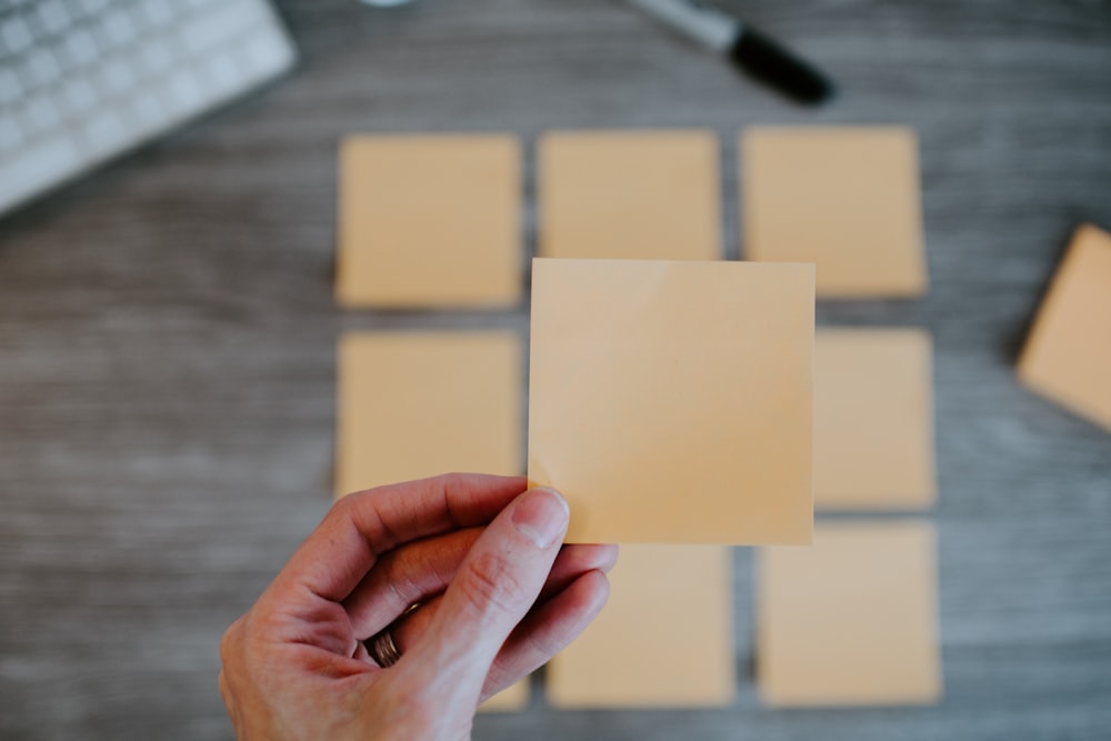 person holding white printer paper