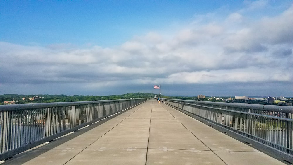 gray concrete bridge under blue sky during daytime