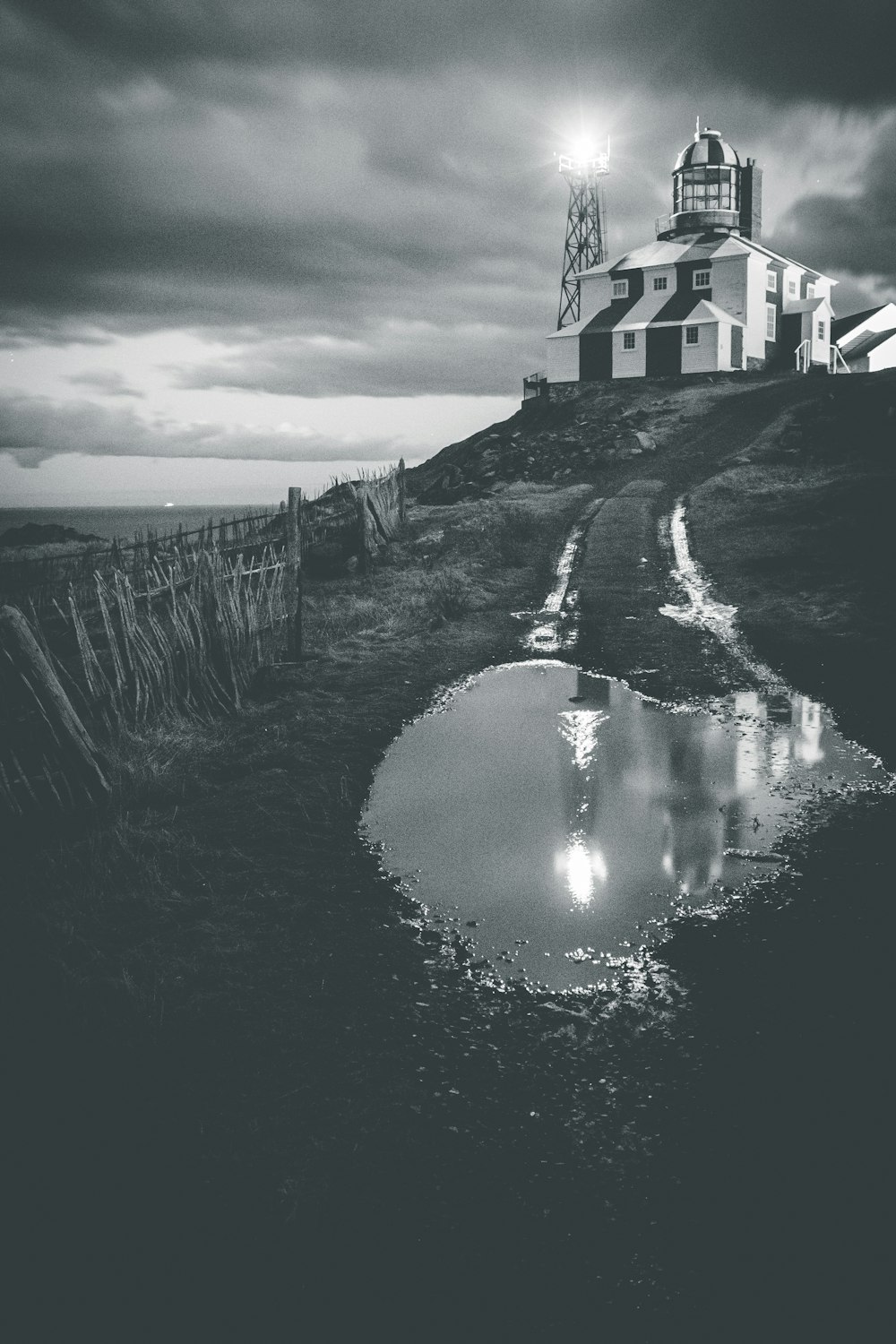 grayscale photo of body of water near house