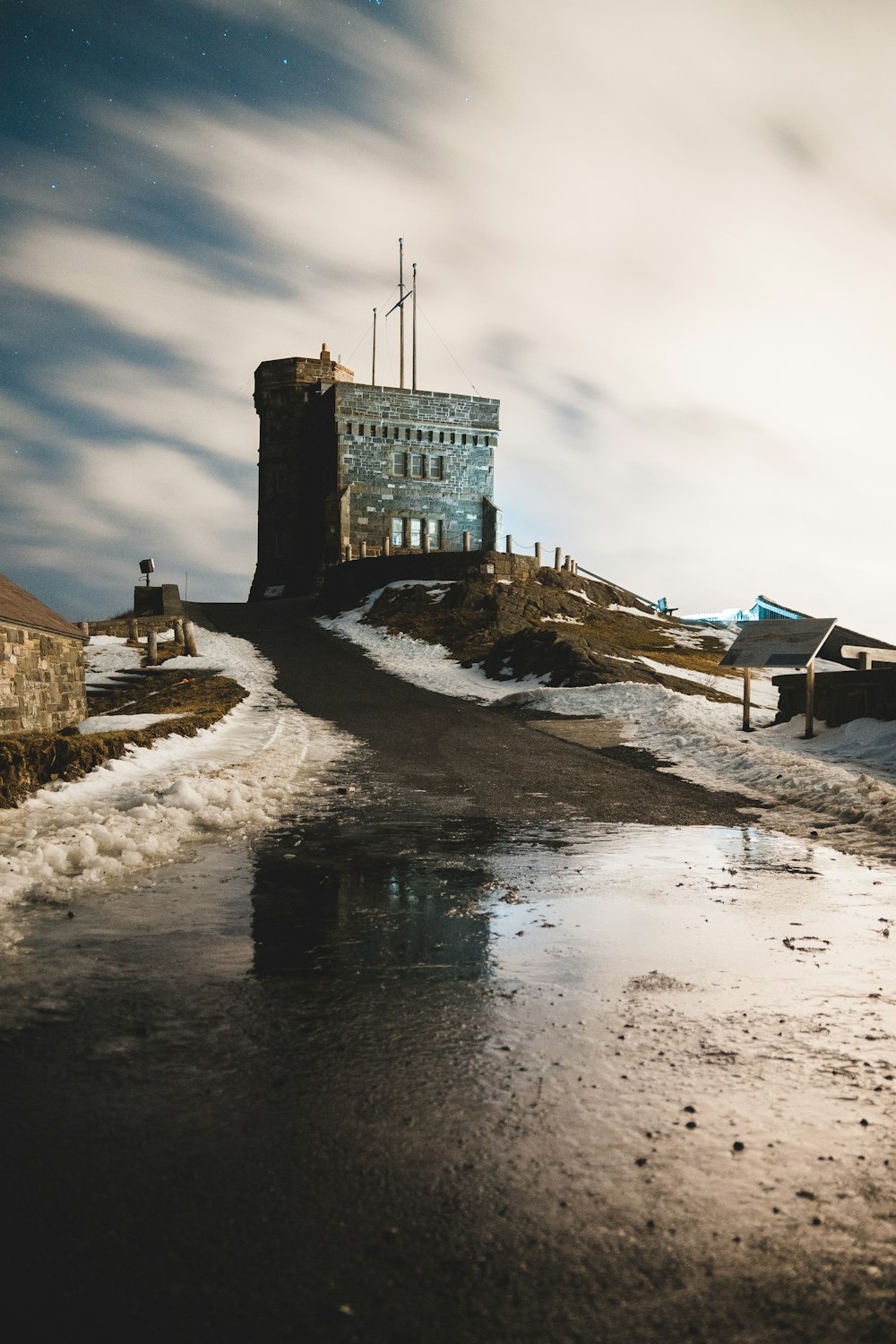 brown concrete building on snow covered ground during daytime