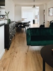 green sofa beside black wooden table