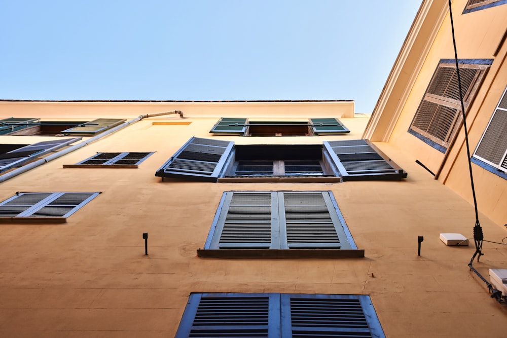 brown concrete building with blue windows