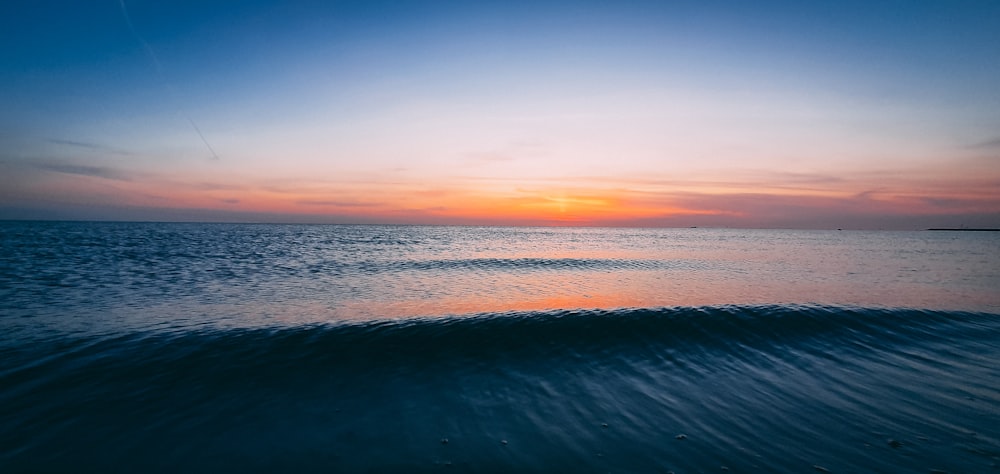 body of water during sunset