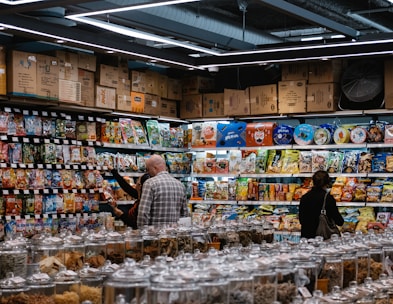 Shelves filled with a variety of packaged grocery products in a cozy market aisle.